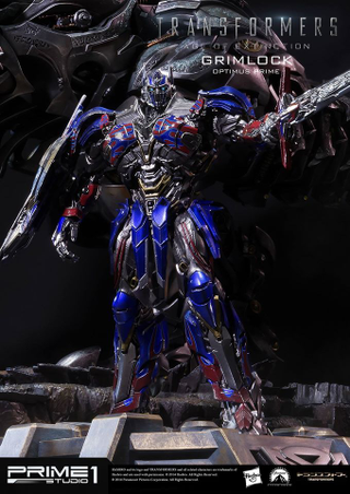 Illustration for article titled Glorious Grimlock and Optimus Prime Statue